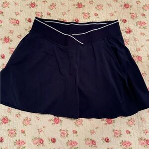 Lululemon high-rise navy tennis skirt with side pockets, size 6, like new